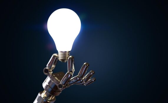 a robotic hand holding a lighbulb. AI in Manufacturing